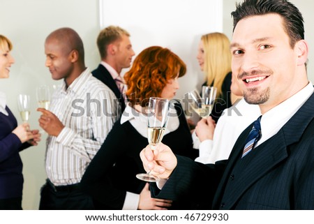People in business outfit celebrating something in the office or at a gathering, maybe they toast on a successful deal or something the like