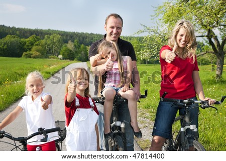 Family riding bicycles in spring