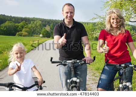 Family riding bicycles in spring