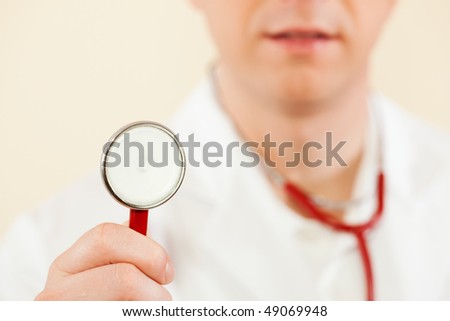 Medical doctor with stethoscope, focus is on the work tool