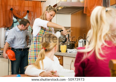 Family doing their breakfast routine in the morning, dad is ready to start to work