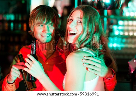 Couple having drinks in a bar or nightclub