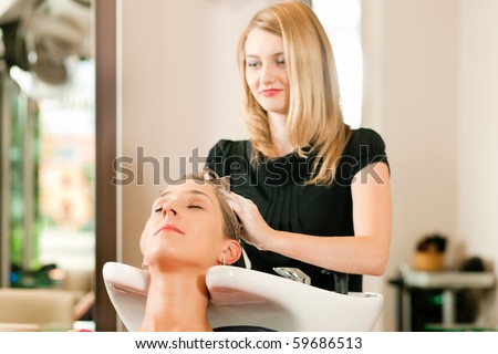Woman at the hairdresser getting her hair washed and rinsed feeling visibly well