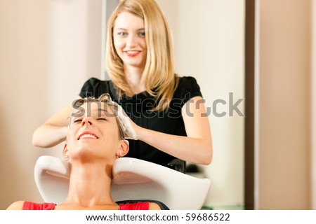 Woman at the hairdresser getting her hair washed and rinsed feeling visibly well