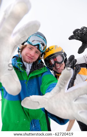 Skier and snowboarder in the snow posing for the camera