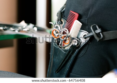 Closeup of Scissor bag or holster of hairdresser worn around the hip with lots of tools