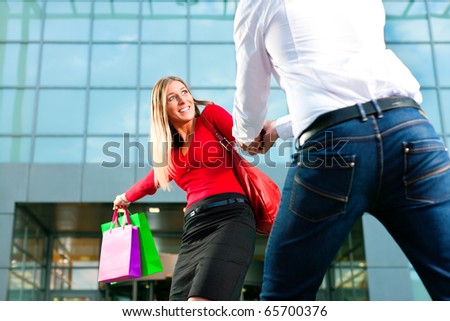 Woman wants to shop into mall, dragging her man or boyfriend to join
