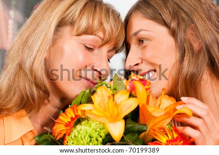Mother and daughter Ã¢Â?Â? the daughter has given her mother flowers