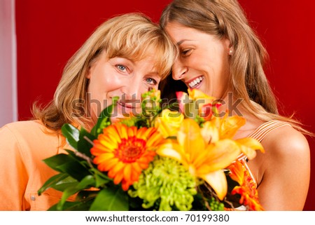Mother and daughter Ã¢Â?Â? the daughter has given her mother flowers
