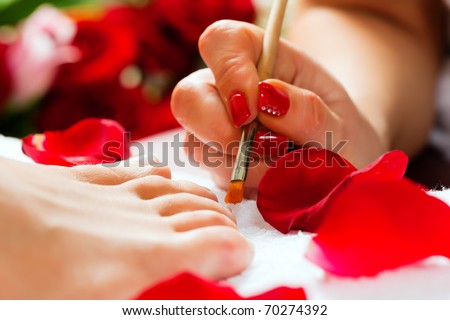 Woman receiving pedicure in a Day Spa; lots of flowers in the background