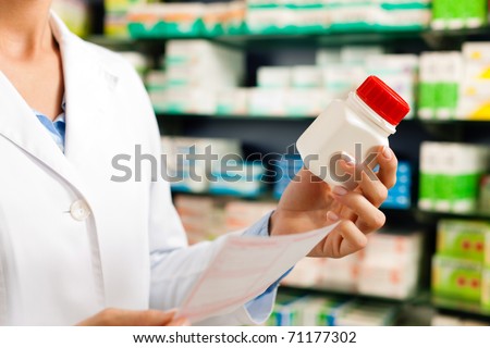 Female pharmacist Ã¢Â?Â? only hands to be seen Ã¢Â?Â? standing in pharmacy with pharmaceuticals