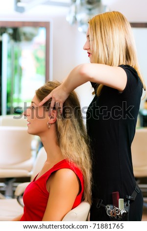 Woman at the hairdresser getting a head massage in the salon