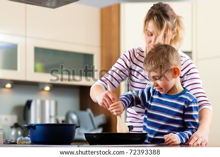Family cooking in their kitchen Ã¢Â?Â? mother and sun cooking spaghetti