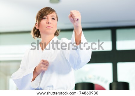 Young woman in martial art training in a gym