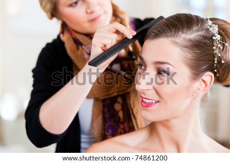 Stylist pinning up a bride\'s hairstyle before the wedding