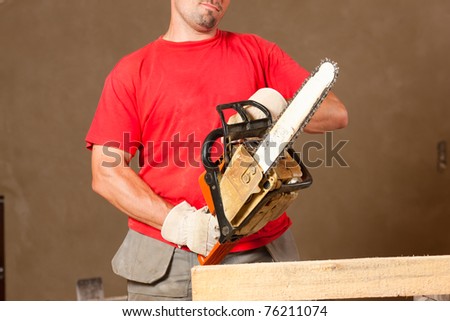 Construction worker with motor saw doing some renovation
