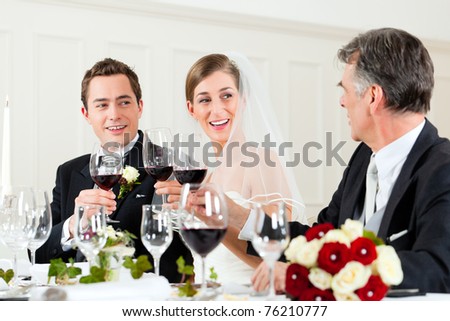 Wedding party at dinner - Bridal couple with father of bride