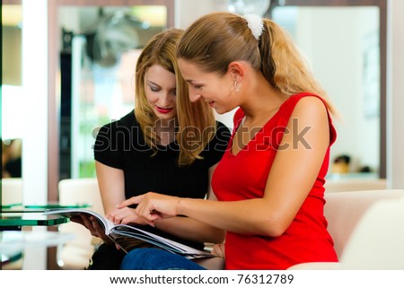 Woman at the hairdresser getting advise on her hair styling or new hair color