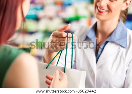 Female pharmacist with a female customer in her pharmacy Female pharmacist with a female customer in her pharmacy