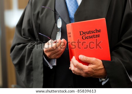 Lawyer with civil law code - only torso to be seen, close-up
