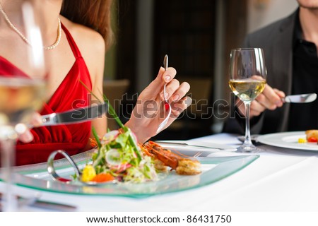 Couple for romantic Dinner or lunch in a gourmet restaurant drinking wine and eating Couple for romantic Dinner or lunch in a gourmet restaurant drinking wine and eating