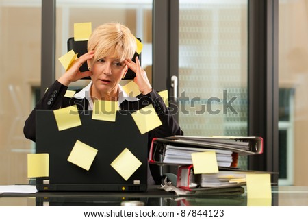 woman having stress in the office - multitasking and time management