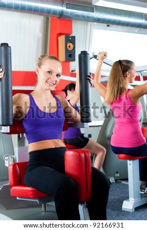 Three young women doing strength or sports training in gym for a better fitness