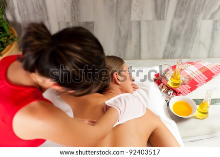 Wellness - woman getting massage in Spa; the therapist is using a glove