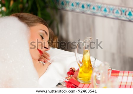 Wellness - woman getting massage in Spa; it is a massage with foam