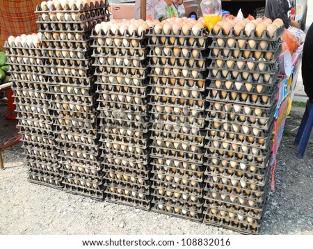 Fresh eggs in a plastic tray on the market.