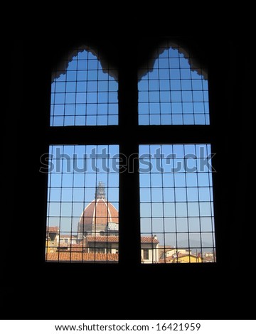 Window frames form a cross as one looks out at Brunelleschi\'s Dome in Florence Italy