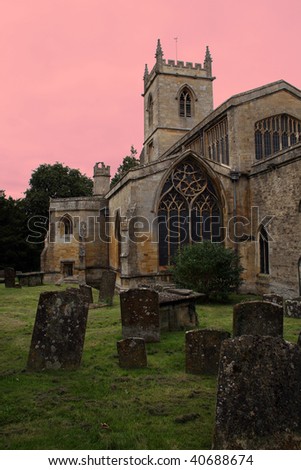 Tombstones in a Church Yard Cemetery with glowing Skies