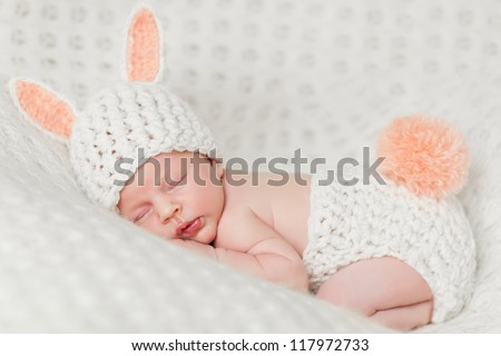 baby sleeps in a rabbit costume