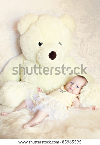 cute newborn lies with the teddy bear