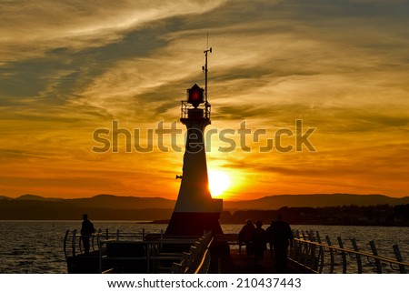 Lighthouse silhouette at Ogden Point Victoria, British Columbia, Canada at sunset
