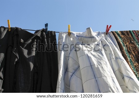 Laundry joyful summer. white, old linen shirt line and blue sky.