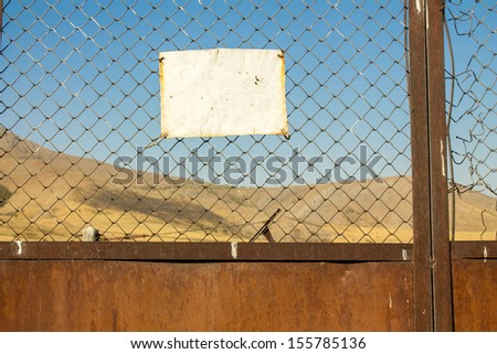 Forbidden sign on the chain-link fence