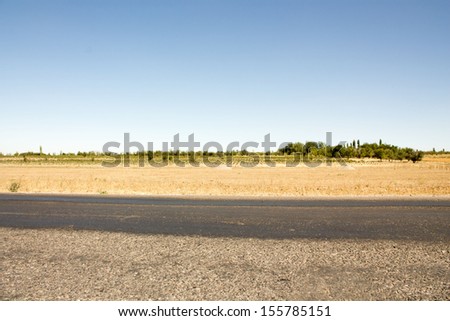 The road between the town and village in Kazakhstan