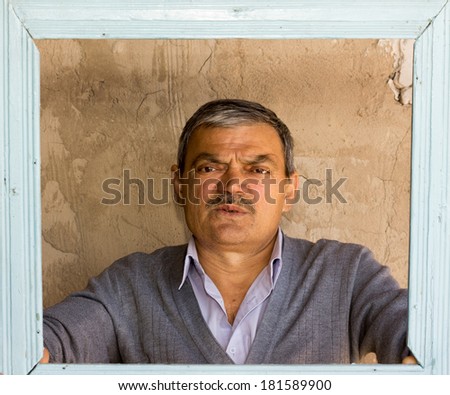 portrait of an old man with a frame
