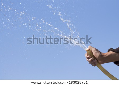 splashing water in hand on blue background