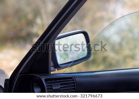 Shoot in rear-view mirror of car .