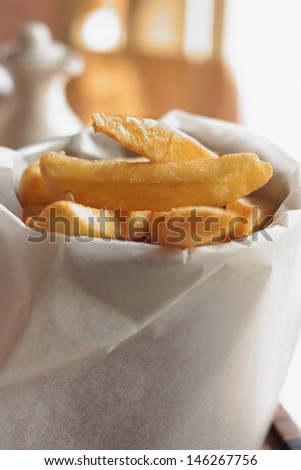 Gourmet style fried potato chips with selective focus on the top two chips