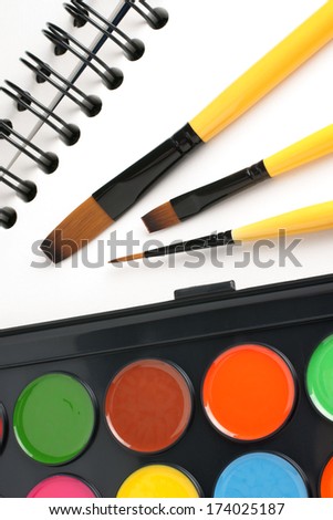 Paint brushes sketch book and paints
