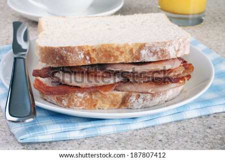 Bacon Sandwich or bacon butty selective focus on the bacon