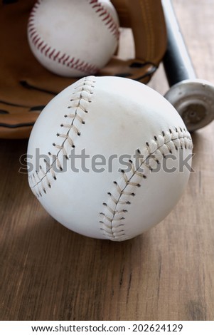 Old well used baseballs with mitt and bat