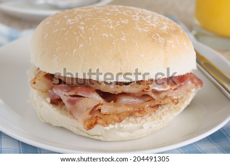 Bacon Sandwich or bacon roll selective focus on the bacon