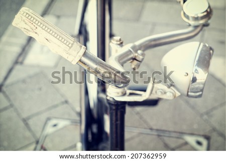 Vintage Bicycle with vintage filter and shallow focus on handle bars