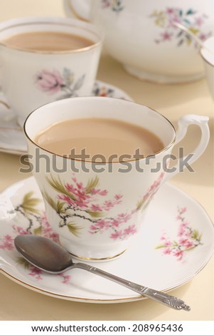 Afternoon tea served in vintage floral mismatched cups and saucers