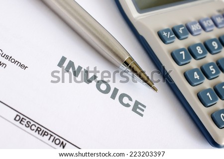 Invoice letter head with pen and calculator