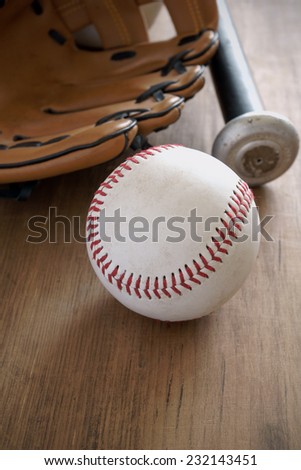Old well used baseball with mitt and bat